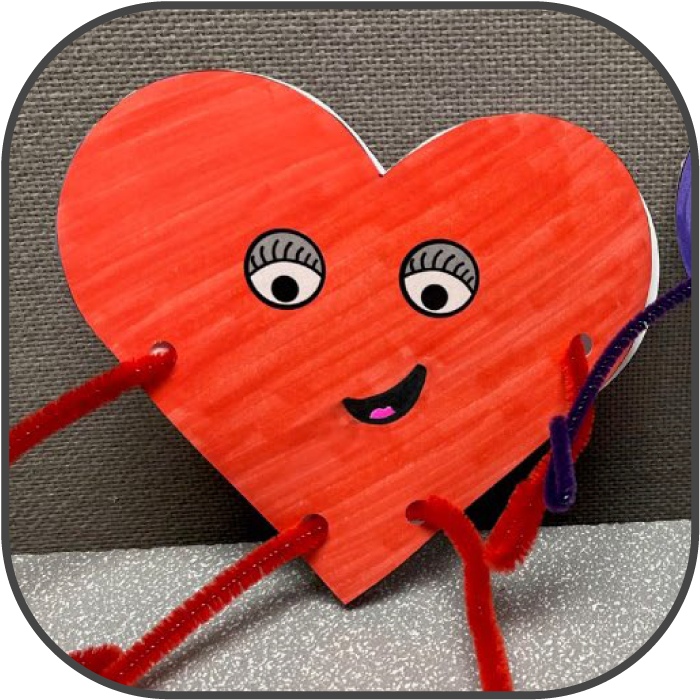 Heart shaped greeting card with a face and pipe cleaner arms and legs