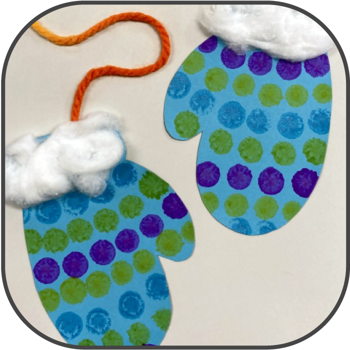 Paper mittens painted with polka dots and cotton ball cuffs