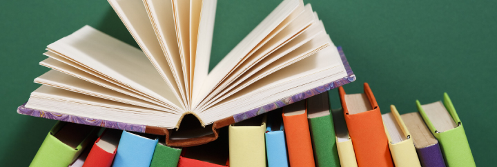 Colorful book spines and one open book