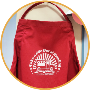 Red apron with a graphic showing a food truck and 'Take a Bite Out of Reading'