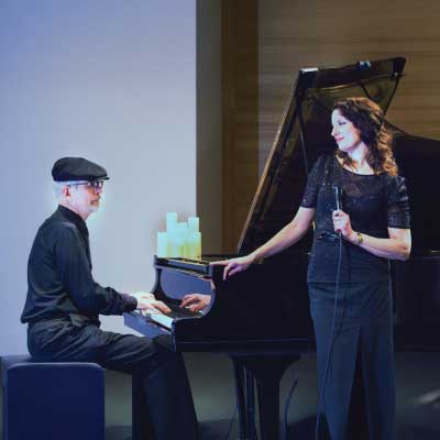 Dennis playing the piano and Petra singing